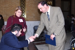 Ben, a MWCIL consumer, shakes hands with State Senator James Eldridge, while Pat, an IL Coordinator at MWCIL, looks on.