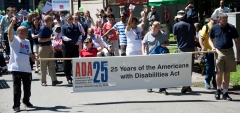 marchers with banner - 25 years of the americans with disabilities act