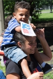 little boy on woman's shoulders with ADA 25 sign