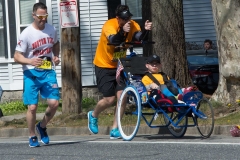 man pushing wheelchair