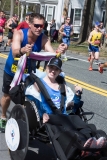 man pushing smiling woman in wheelchair