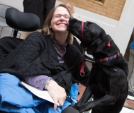 Woman with guide dog licking her face
