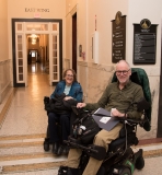 2 advocates in wheelchairs in state house hallway
