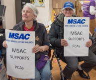 2 women from Mass Senior Action Council indoors