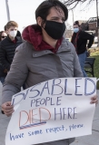 Advocate with sign: Disabled People Died Here.  Have some respect, please"