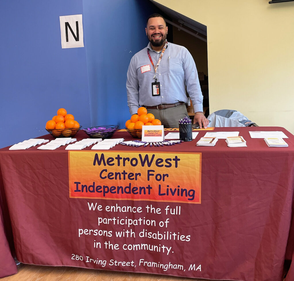 Elvin behind the MWCIL Options Counseling table