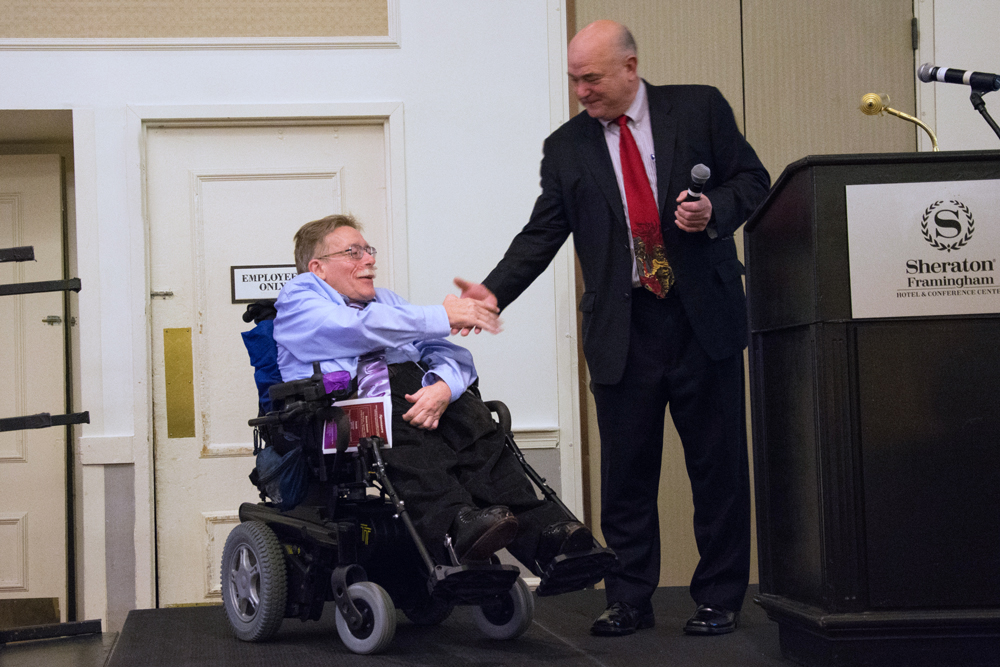 Ed and Paul shake hands while receiving award