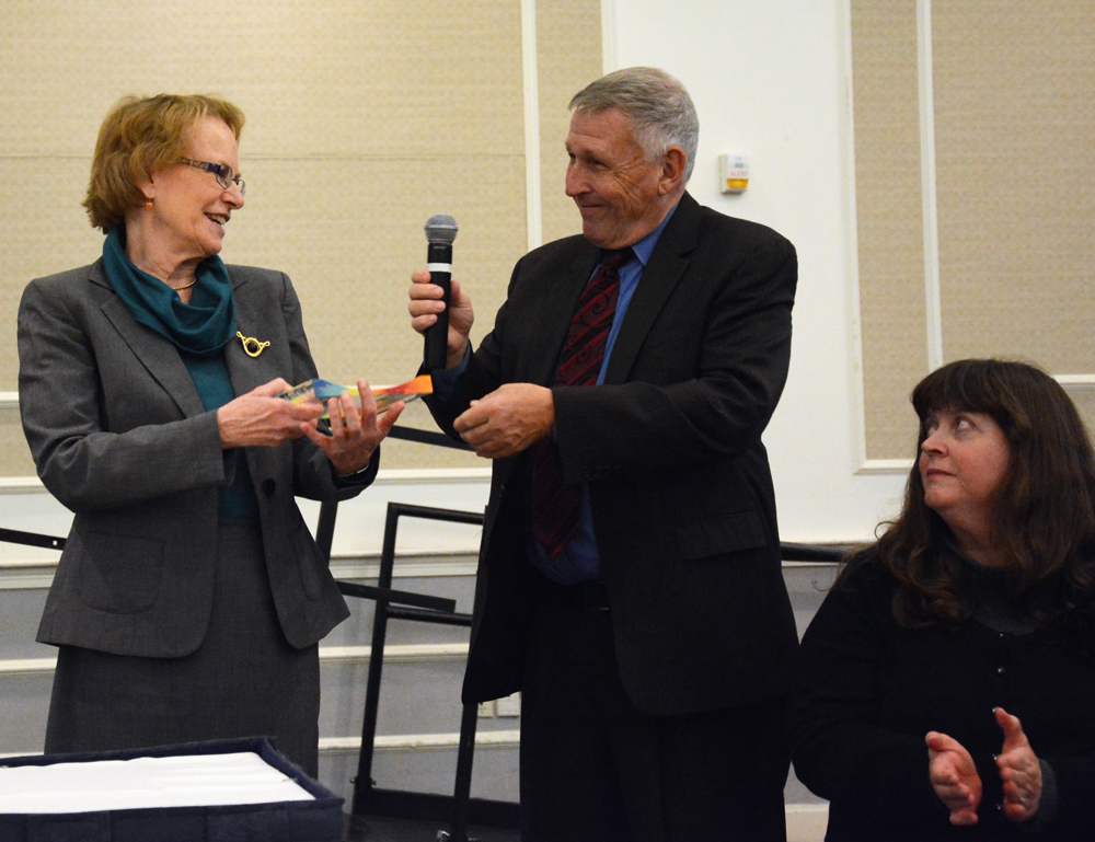 Bill Allan presents Rep. Story with an award as Tory looks on.